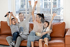 Overjoyed excited family football fans watching sport tv celebrating goal