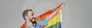 Overjoyed gay man holding lgbt flag