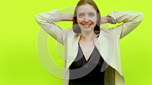 Overjoyed giggling woman celebrating success in space studio on yellow