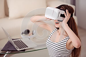 Overjoyed girl wearing virtual reality device