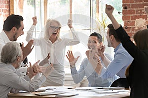 Overjoyed happy corporate business team people scream celebrate triumph