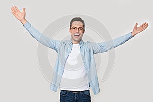 Overjoyed happy man standing with his hands wide open