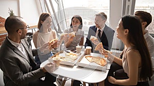 Overjoyed happy mixed race company employees celebrating special occasion.