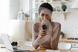 Overjoyed hispanic female remote student read good news on cell