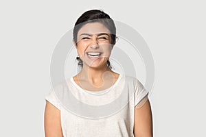 Overjoyed indian girl laugh posing on grey background