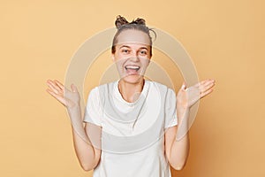 Overjoyed laughing woman wearing white T-shirt washes hair using good shampoo for maintaining the health and cleanliness of her