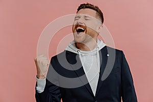 Overjoyed man raising clenched fist and celebrating achievements