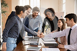 Overjoyed multiracial employees participate in teambuilding activity