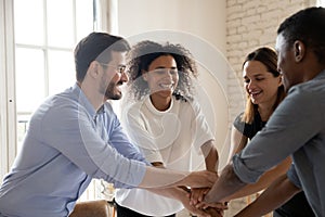 Overjoyed multiracial group engaged in funny teambuilding activity.