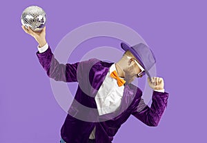 Overjoyed performer with disco ball dancing