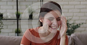 Overjoyed positive millennial pretty caucasian girl laughing at funny joke.