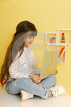 Overjoyed school girl with laptop. Online lesson video call. Kid listen teacher.