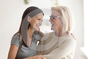 Overjoyed senior mother and grownup daughter have fun together