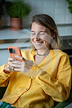 Overjoyed smiling positive woman with mobile phone, having video online call with friends, relatives