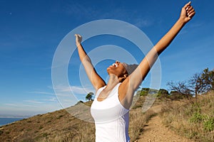 Overjoyed woman outdoors with her arms wide open