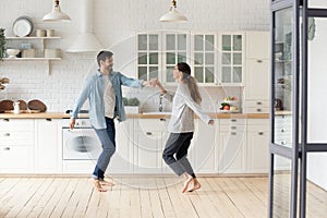 Overjoyed young couple have fun celebrating moving to new home photo