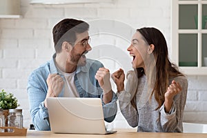 Overjoyed young family spouse celebrating online lottery win.