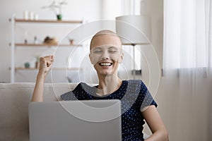 Overjoyed young hairless woman getting good news.