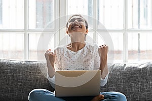 Overjoyed young indian woman celebrating personal achievement.