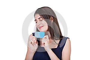 Overjoyed young woman holding to chest her favorite credit card. Close up portrait of a dreamy girl with eyes closed wishing for