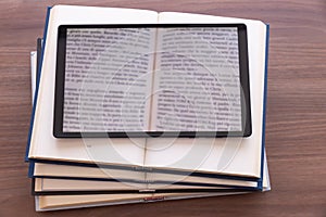 Overlapping open books, with a tablet on top.