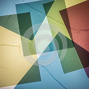 Overlapping translucent geometric shapes create an abstract pattern with a mix of