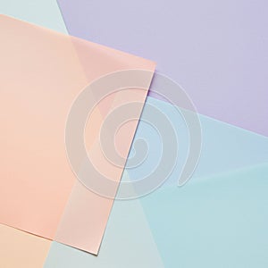 Overlapping translucent sheets create a geometric pattern. The arrangement features