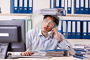 The overloaded busy employee with too much work and paperwork