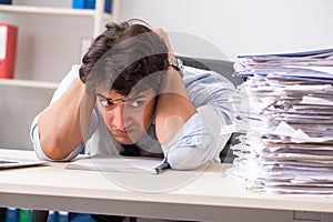 The overloaded busy employee with too much work and paperwork