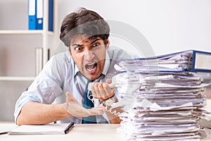 The overloaded busy employee with too much work and paperwork