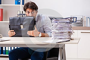 The overloaded busy employee with too much work and paperwork