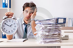 The overloaded busy employee with too much work and paperwork