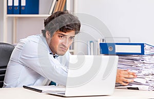 Overloaded busy employee with too much work and paperwork