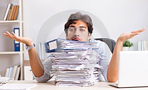 Overloaded busy employee with too much work and paperwork