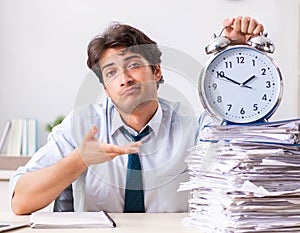 Overloaded busy employee with too much work and paperwork