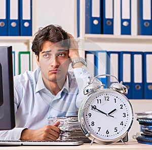 Overloaded busy employee with too much work and paperwork