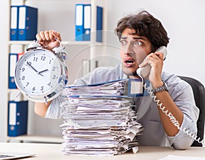 Overloaded busy employee with too much work and paperwork