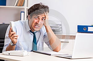 Overloaded busy employee with too much work and paperwork