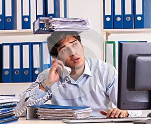 Overloaded busy employee with too much work and paperwork