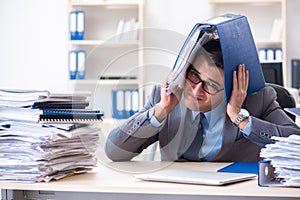 The overloaded with work employee under paperwork burden
