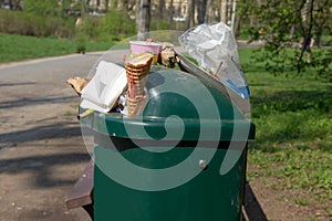 Overloading garbage containers in a park