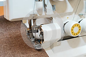 Overlock sewing machine in process. Professional equipment