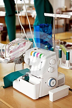 Overlock sewing machine in tailor office. Fashion designer equipment serger in a sewing workshop