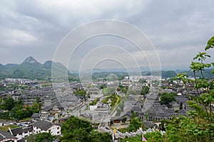Overlook to ancient town in mountains on cloudy spring day