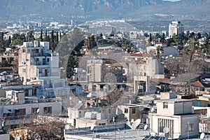 Overlooking the dense Nicosia cityscape with buildings and mountains in the background
