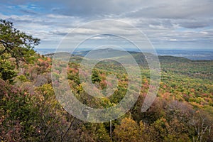 Overlooking the Shawangunk Mountain Range surrounded by bright fall foliage on a partly cloudy afternoon at Minnewaska State Park,