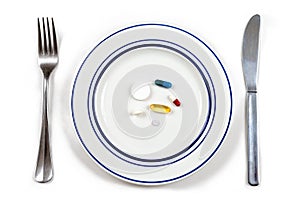 Overmedication -Capsules and hidden in a plate-Conceptual photo.