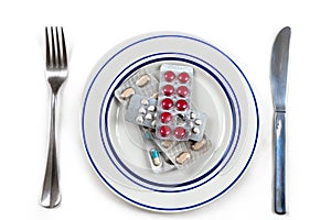 Overmedication -Capsules and hidden in a plate-Conceptual photo.