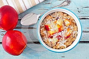 Overnight breakfast oats with peach and coconut, overhead scene photo