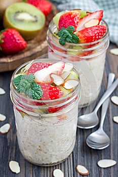 Overnight oatmeal with fresh strawberry and kiwi in glass jar